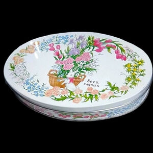 VINTAGE Oval See's Easter candy tin with flowers and a bunny. 10" by apx 7".  D4